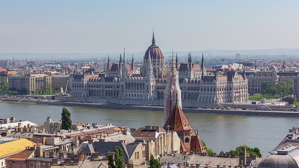 Exterior view of the Hungarian Parliament Building's neo-Gothic facade and dome in Budapest